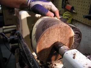 The Splintershop - Wood Art from the Lathe. A walnut bowl blank has been rough-turned into a cylinder, ready for profile cuts.