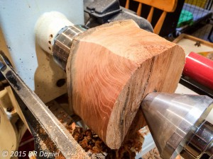 A cherry turning blank being rough-turned into a cylinder